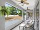 Relaxing screened porch with ceiling fans, furniture and views of the fenced backyard at 808 Hickory Glen Dr, Seffner, FL 33584