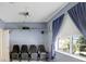 Home theater featuring four theater seats, shelves for equipment, projector and blue curtains at 808 Hickory Glen Dr, Seffner, FL 33584