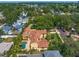 An aerial view of a home features a barrel tile roof, a private pool and lush landscaping at 843 17Th N Ave, St Petersburg, FL 33704