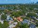Aerial shot displays a mediterranean-style home near a serene lake and a distant cityscape at 843 17Th N Ave, St Petersburg, FL 33704