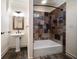 Neutral bathroom featuring custom tiled shower, modern sink with framed mirror and wood look flooring at 843 17Th N Ave, St Petersburg, FL 33704