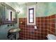 Unique bathroom featuring decorative sink, mirror, and tile accent wall at 843 17Th N Ave, St Petersburg, FL 33704