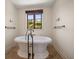 Bright bathroom featuring a luxurious soaking tub with black vintage style faucet, and natural light at 843 17Th N Ave, St Petersburg, FL 33704