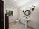 This cozy bathroom features a pedestal sink, toilet, and traditional vanity lighting at 843 17Th N Ave, St Petersburg, FL 33704