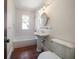 Bathroom with pedestal sink, white tiled walls and separate toilet and shower at 843 17Th N Ave, St Petersburg, FL 33704