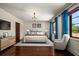Inviting bedroom with hardwood floors, bright curtains, and a cozy armchair at 843 17Th N Ave, St Petersburg, FL 33704