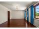 Bedroom with beautiful hardwood floors, bright windows, and blue curtains at 843 17Th N Ave, St Petersburg, FL 33704