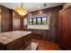 Walk-in closet with custom wood cabinetry, marble countertop, island, and a view to lush landscaping at 843 17Th N Ave, St Petersburg, FL 33704
