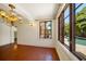 The dining room has terracotta tile flooring, a decorative chandelier, and a pool view at 843 17Th N Ave, St Petersburg, FL 33704