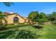 Exterior view of a home with a lush green lawn and mature trees providing ample shade at 843 17Th N Ave, St Petersburg, FL 33704