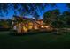 Stunning two-story home with lush landscaping, a red tile roof, and a large arched window at 843 17Th N Ave, St Petersburg, FL 33704