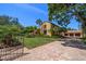 Elegant exterior of home featuring a manicured lawn, brick driveway, and well-maintained greenery at 843 17Th N Ave, St Petersburg, FL 33704