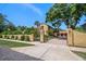 Beautiful exterior of a home with a brick driveway, secure gate, and well-maintained landscaping at 843 17Th N Ave, St Petersburg, FL 33704
