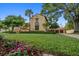 Beautiful home with lush green lawn, mature trees and manicured landscaping at 843 17Th N Ave, St Petersburg, FL 33704