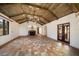 Spacious living room with wooden beamed vaulted ceilings, fireplace and unique tiled floors at 843 17Th N Ave, St Petersburg, FL 33704