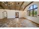 Sunlit living room features wood-beamed ceilings, arched window, and gorgeous tile flooring at 843 17Th N Ave, St Petersburg, FL 33704