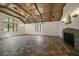 Bright living room features a stone fireplace, wood-beamed ceilings, and tile floors at 843 17Th N Ave, St Petersburg, FL 33704