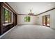 This expansive living room with built-in shelves and a window overlooks the lush garden at 843 17Th N Ave, St Petersburg, FL 33704