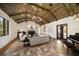 Elegant living room featuring a vaulted wood ceiling, stone fireplace, and terra cotta tile floors at 843 17Th N Ave, St Petersburg, FL 33704
