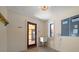 Bright mud room features utility sink, wood door, and cream walls at 843 17Th N Ave, St Petersburg, FL 33704