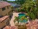 An aerial view showcases a beautiful home with a sparkling pool and lush landscaping at 843 17Th N Ave, St Petersburg, FL 33704