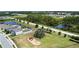 Aerial view showcasing playground, houses, pond, and green spaces in a Gathering-friendly neighborhood at 8595 Prairie Creek Dr, New Port Richey, FL 34655