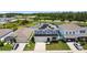 Aerial view of a well-situated two-story home featuring solar panels and beautiful landscaping at 8595 Prairie Creek Dr, New Port Richey, FL 34655