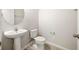 Well-lit half bathroom featuring a pedestal sink and neutral tones at 8595 Prairie Creek Dr, New Port Richey, FL 34655