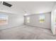 Spacious bedroom with neutral carpet, ceiling fan, and lots of natural light from three windows at 8595 Prairie Creek Dr, New Port Richey, FL 34655