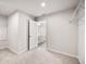 Bright bedroom features neutral carpet and an ensuite bathroom, offering comfort and convenience at 8595 Prairie Creek Dr, New Port Richey, FL 34655