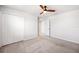 Bedroom features a modern fan and double closet doors at 8595 Prairie Creek Dr, New Port Richey, FL 34655