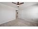 Bedroom has a modern ceiling fan, a view into the bathroom, and a walk-in closet at 8595 Prairie Creek Dr, New Port Richey, FL 34655