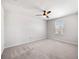 Neutral bedroom featuring a window and modern ceiling fan at 8595 Prairie Creek Dr, New Port Richey, FL 34655