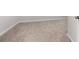 Walk-in closet featuring neutral carpet, white baseboards, and a white door at 8595 Prairie Creek Dr, New Port Richey, FL 34655