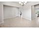 Open dining area with neutral walls and tile flooring with views of the stairway and kitchen at 8595 Prairie Creek Dr, New Port Richey, FL 34655