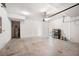 A spacious garage featuring white walls, concrete flooring, and a water heater at 8595 Prairie Creek Dr, New Port Richey, FL 34655