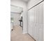 Hallway view of the kitchen featuring stainless steel appliances and white cabinets at 8595 Prairie Creek Dr, New Port Richey, FL 34655