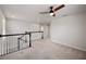 Upstairs hallway featuring neutral carpet, white walls, and a ceiling fan at 8595 Prairie Creek Dr, New Port Richey, FL 34655