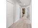 Hallway with neutral carpet leads to bedrooms and bathrooms, offering easy access and convenience at 8595 Prairie Creek Dr, New Port Richey, FL 34655