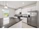 Bright kitchen featuring stainless steel appliances, granite countertops, and ample storage at 8595 Prairie Creek Dr, New Port Richey, FL 34655