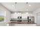 Bright kitchen with white cabinets, granite countertops, and stainless steel appliances at 8595 Prairie Creek Dr, New Port Richey, FL 34655