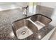 Close-up of a kitchen sink with a granite countertop and stainless steel faucet at 8595 Prairie Creek Dr, New Port Richey, FL 34655