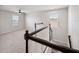 This neutral carpeted loft features abundant natural light and modern railings at 8595 Prairie Creek Dr, New Port Richey, FL 34655