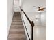 Carpeted staircase with white railings leading to the upper level of the house at 8595 Prairie Creek Dr, New Port Richey, FL 34655