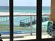 View from a balcony overlooking a pedestrian bridge, beach, and the ocean at 880 Mandalay Ave # N109, Clearwater Beach, FL 33767
