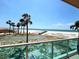 Balcony view of a shuffleboard court, a beach, and the ocean at 880 Mandalay Ave # N109, Clearwater Beach, FL 33767