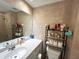 Well-lit bathroom featuring a large vanity, toilet, and shelf for storage at 880 Mandalay Ave # N109, Clearwater Beach, FL 33767