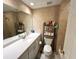 Bathroom featuring a spacious vanity, large mirror, and neutral tile at 880 Mandalay Ave # N109, Clearwater Beach, FL 33767