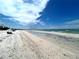 Wide sandy beach on a sunny day with clear blue skies at 880 Mandalay Ave # N109, Clearwater Beach, FL 33767