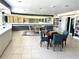 Bright game room with tile flooring, library and tables for games and reading at 880 Mandalay Ave # N109, Clearwater Beach, FL 33767